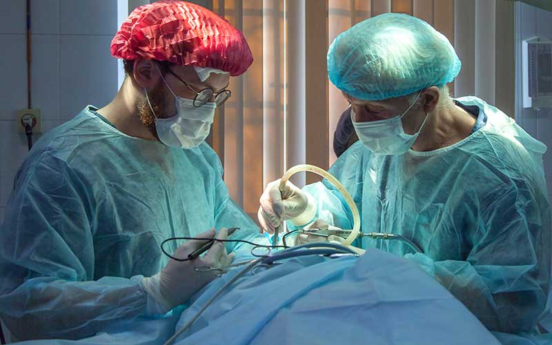 Surgeons performing a procedure — Sharma Hospital, Kotputli